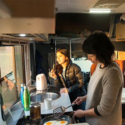 Family cooking in Apollo motorhome